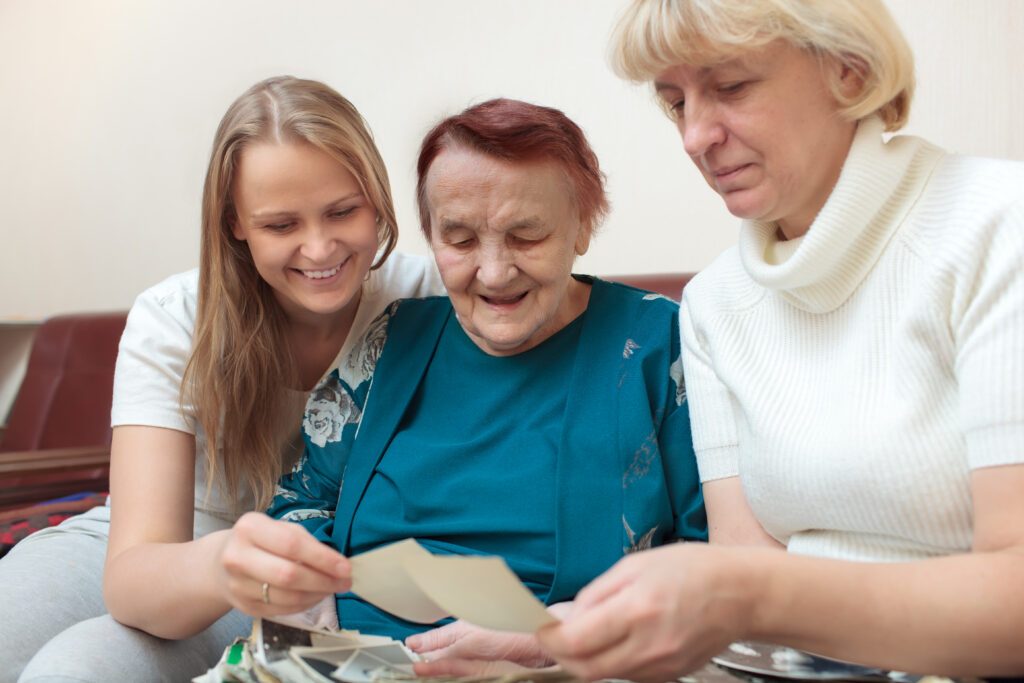 mother daughter and grandmother looking at photos