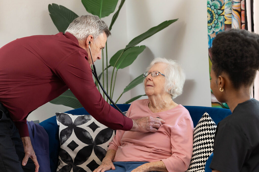 Senior care professional checking an elderly woman during a home health care visit in Oklahoma City