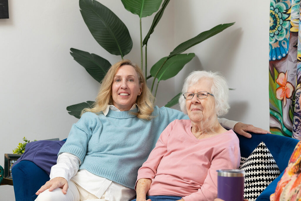 Family caregiver sitting with her elderly mother during an in-home senior care visit in Oklahoma City