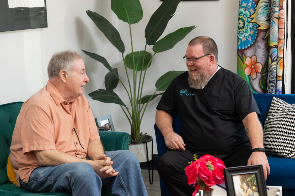 Senior Care at Home caregiver talking with an older man during a home visit, supporting independent living through compassionate elder care and preventive home care services.